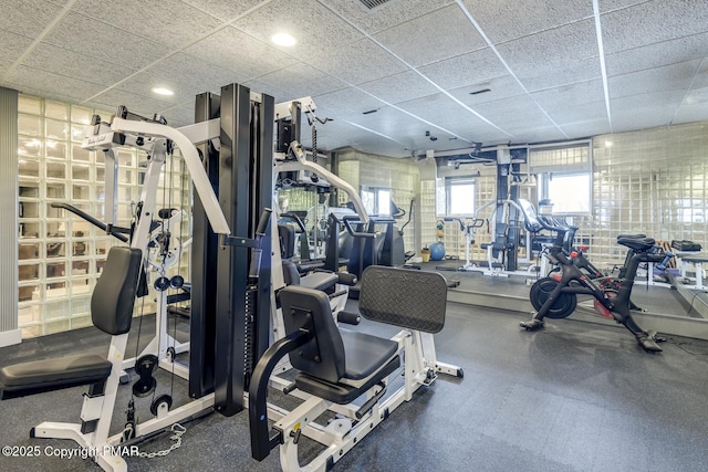 gym with a paneled ceiling