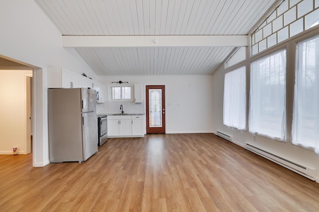 kitchen featuring lofted ceiling with beams, baseboard heating, freestanding refrigerator, electric range, and a sink