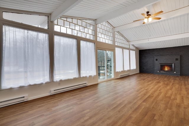 unfurnished living room with a brick fireplace, a baseboard heating unit, and wood finished floors