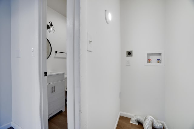 laundry area featuring dark wood-style floors, baseboards, laundry area, electric dryer hookup, and washer hookup