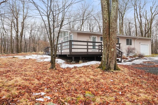 view of front of home with an attached garage and a wooden deck