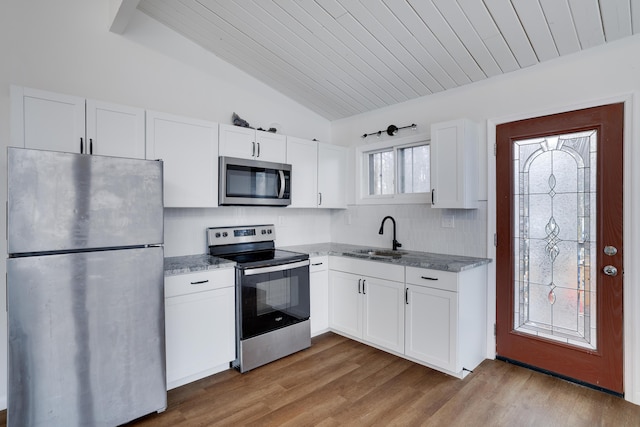 kitchen with white cabinets, appliances with stainless steel finishes, wood finished floors, and a sink