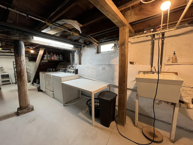 basement with separate washer and dryer and a sink