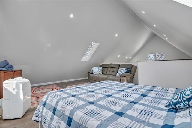 bedroom featuring lofted ceiling with skylight, light wood-type flooring, and baseboards