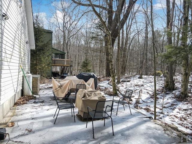 snow covered patio featuring grilling area