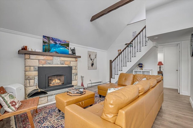 living room with stairway, wood finished floors, a fireplace, vaulted ceiling, and a baseboard heating unit