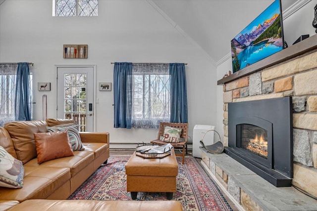 living room with a stone fireplace, high vaulted ceiling, and ornamental molding