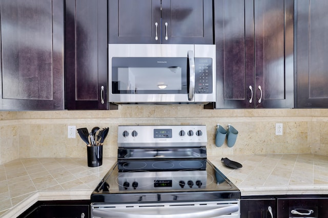 106 Alwen Ave, East Stroudsburg, PA 18301 - kitchen featuring appliances with stainless steel finishes, dark brown cabinetry, tile counters, and decorative backsplash