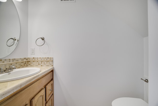 106 Alwen Ave, East Stroudsburg, PA 18301 - bathroom featuring vanity, toilet, and decorative backsplash