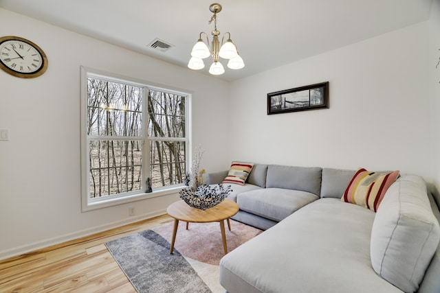 106 Alwen Ave, East Stroudsburg, PA 18301 - living room with a chandelier, wood finished floors, plenty of natural light, and baseboards