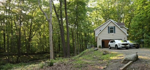 106 Alwen Ave, East Stroudsburg, PA 18301 - view of home's exterior with driveway and a forest view