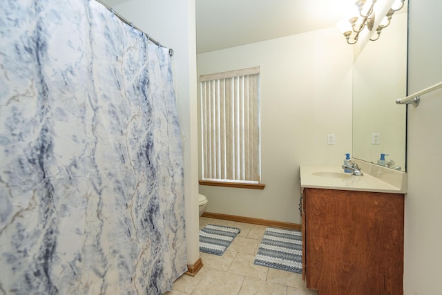 bathroom with curtained shower, baseboards, toilet, vanity, and tile patterned flooring
