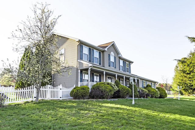 view of front of house with fence and a front yard