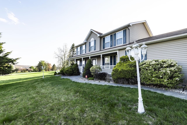 view of property exterior featuring a porch and a lawn