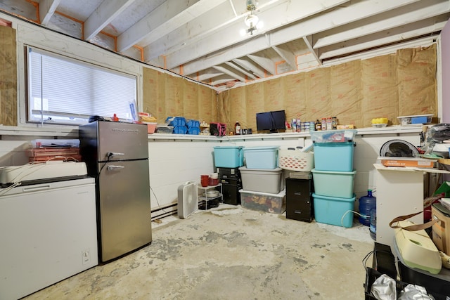 basement featuring freestanding refrigerator and refrigerator