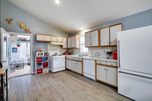 kitchen featuring white appliances, light wood finished floors, lofted ceiling, light countertops, and under cabinet range hood