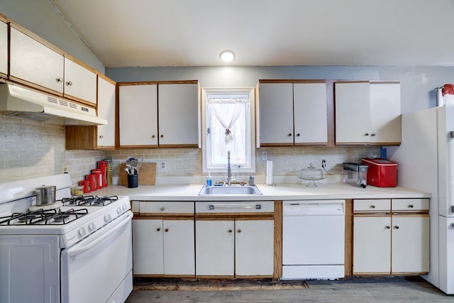 kitchen featuring white appliances, decorative backsplash, light countertops, under cabinet range hood, and a sink