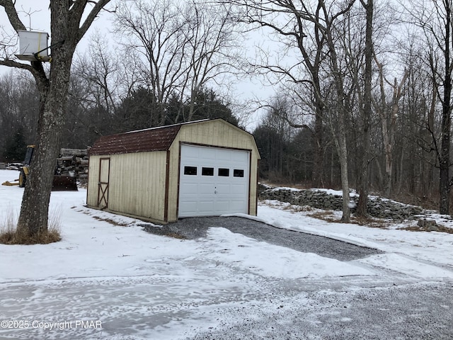 snow covered garage with a garage