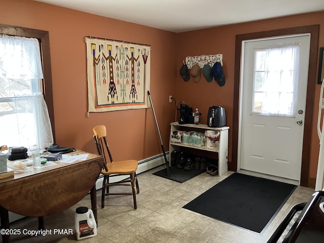 office space featuring a baseboard radiator and light floors