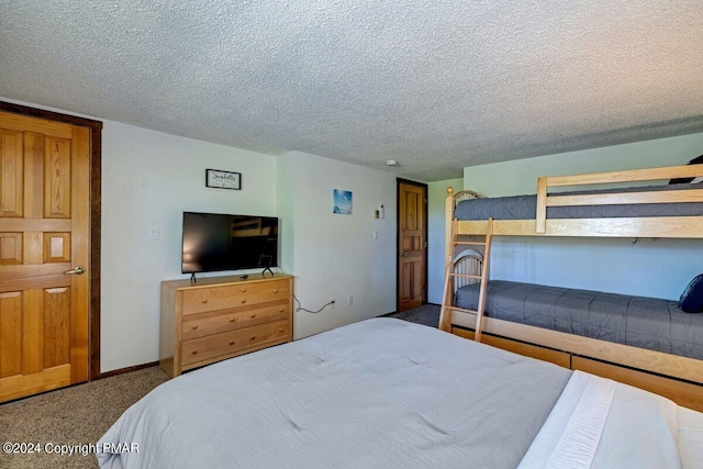 carpeted bedroom featuring a textured ceiling