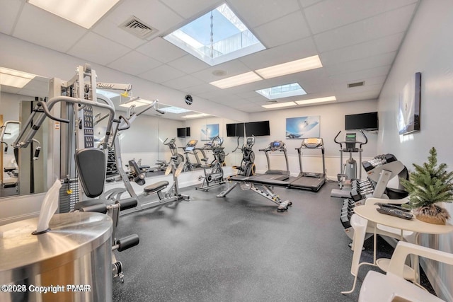 exercise room featuring a paneled ceiling and visible vents