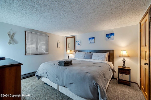 carpeted bedroom featuring a baseboard heating unit and a textured ceiling