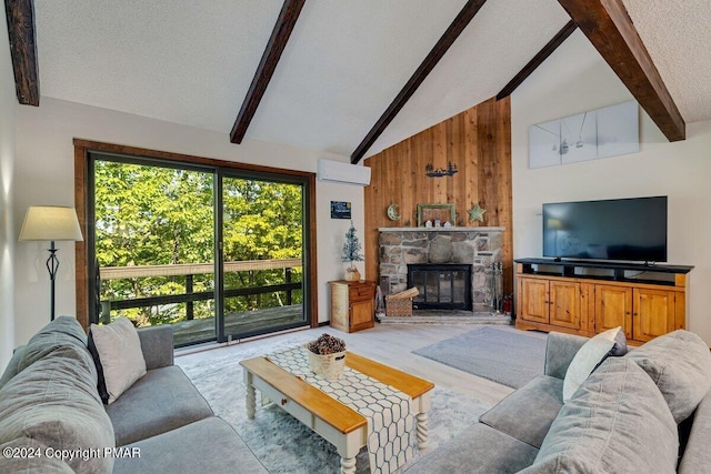 living area featuring wooden walls, a wall unit AC, vaulted ceiling with beams, a textured ceiling, and a stone fireplace