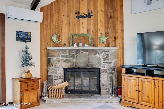 room details with wood finished floors, a stone fireplace, and a wall mounted air conditioner