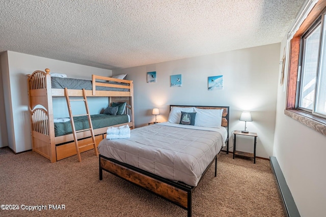 bedroom featuring carpet flooring, a textured ceiling, and baseboards