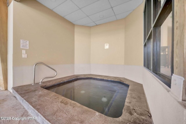 view of swimming pool with an indoor in ground hot tub