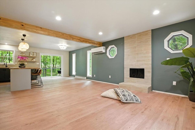 754 Clubhouse Dr, East Stroudsburg, PA 18302 - living room with a wall mounted air conditioner, light wood finished floors, beamed ceiling, recessed lighting, and a tiled fireplace