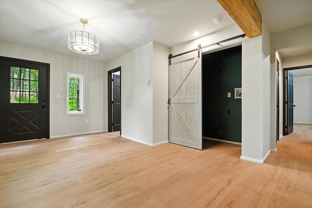 754 Clubhouse Dr, East Stroudsburg, PA 18302 - entrance foyer featuring a barn door, light wood-style floors, and a chandelier