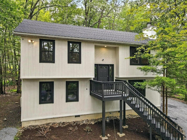 754 Clubhouse Dr, East Stroudsburg, PA 18302 - split foyer home featuring stairway, a chimney, a shingled roof, and view of wooded area