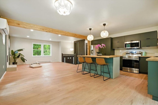 754 Clubhouse Dr, East Stroudsburg, PA 18302 - kitchen featuring stainless steel appliances, light wood finished floors, a breakfast bar, a baseboard radiator, and an AC wall unit