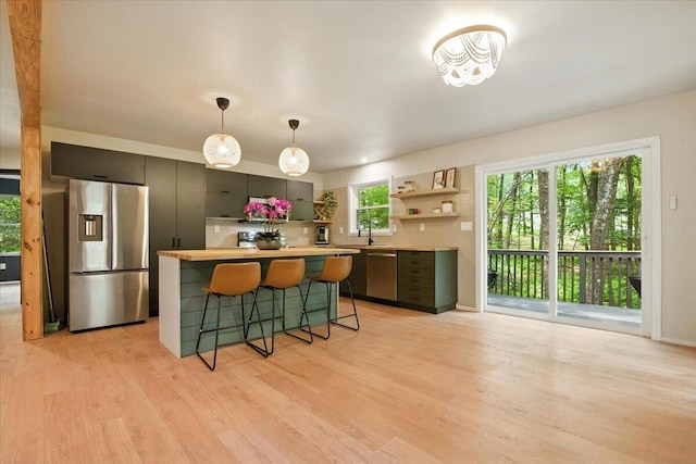 754 Clubhouse Dr, East Stroudsburg, PA 18302 - kitchen with stainless steel appliances, open shelves, a center island, and light wood-style flooring