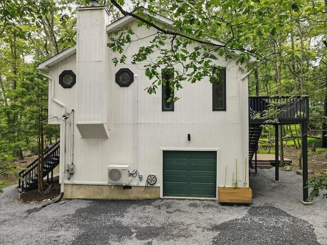 754 Clubhouse Dr, East Stroudsburg, PA 18302 - view of side of property featuring stairway, a garage, a chimney, and a deck