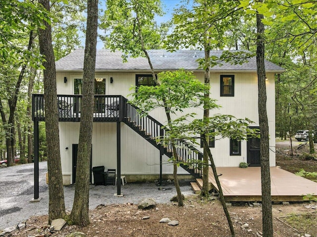 754 Clubhouse Dr, East Stroudsburg, PA 18302 - back of property featuring a wooden deck, stairway, and roof with shingles