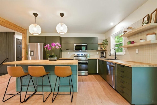 754 Clubhouse Dr, East Stroudsburg, PA 18302 - kitchen featuring stainless steel appliances, green cabinetry, open shelves, butcher block countertops, and tasteful backsplash
