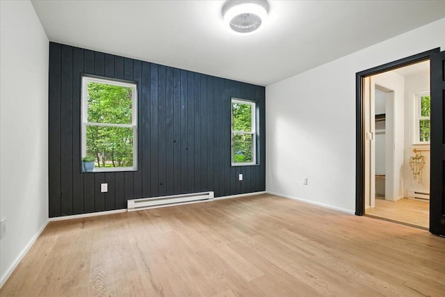 754 Clubhouse Dr, East Stroudsburg, PA 18302 - empty room featuring a baseboard radiator, plenty of natural light, and light wood-type flooring