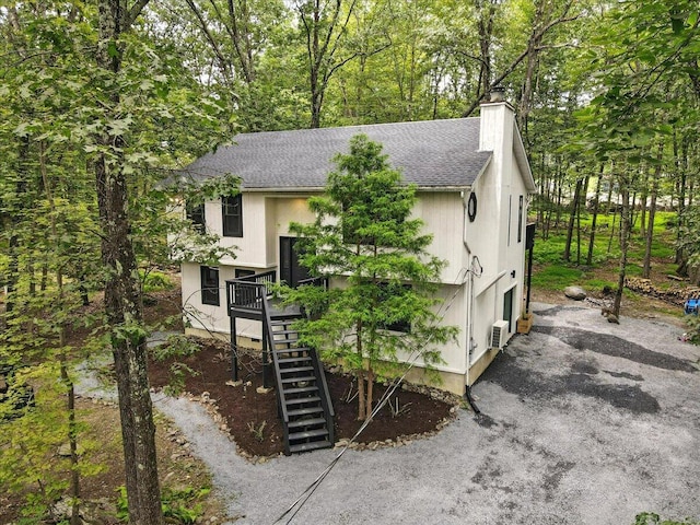 754 Clubhouse Dr, East Stroudsburg, PA 18302 - view of front of property with a shingled roof, a chimney, and stairs