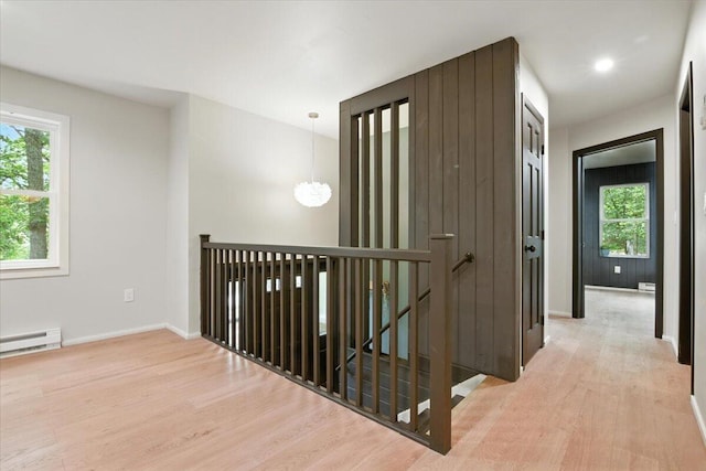 754 Clubhouse Dr, East Stroudsburg, PA 18302 - corridor featuring an upstairs landing, wood finished floors, and a baseboard radiator