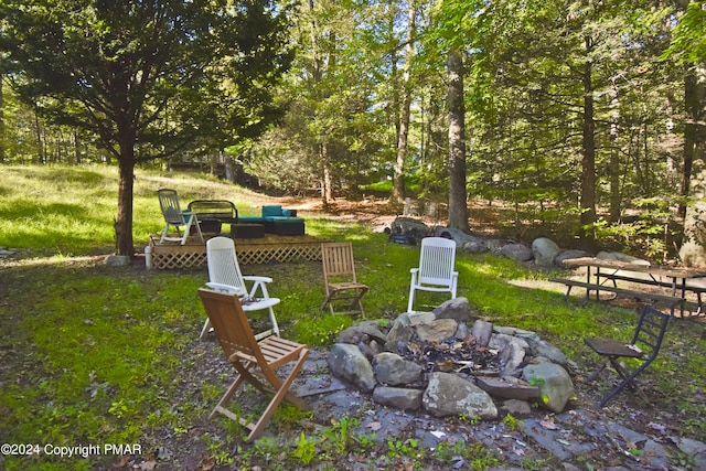 view of yard featuring an outdoor fire pit and a deck