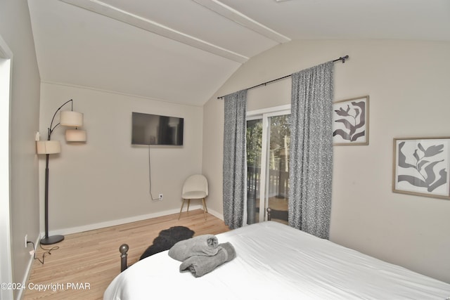 bedroom featuring vaulted ceiling, wood finished floors, and baseboards