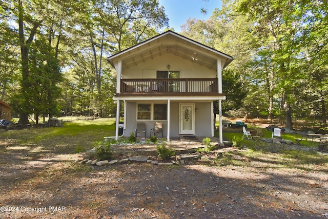 view of front of home with covered porch and a balcony