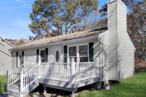 view of front of house featuring a chimney and a deck