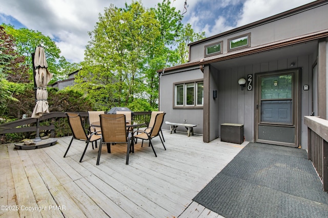 wooden terrace featuring outdoor dining space