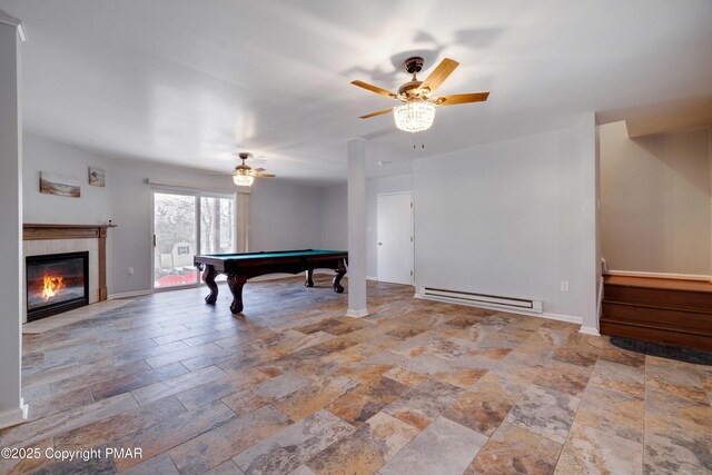 rec room with a fireplace, a baseboard radiator, billiards, and ceiling fan