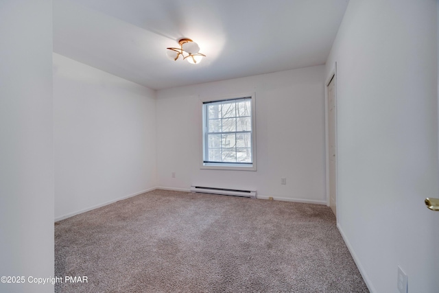 empty room with a baseboard heating unit and carpet floors