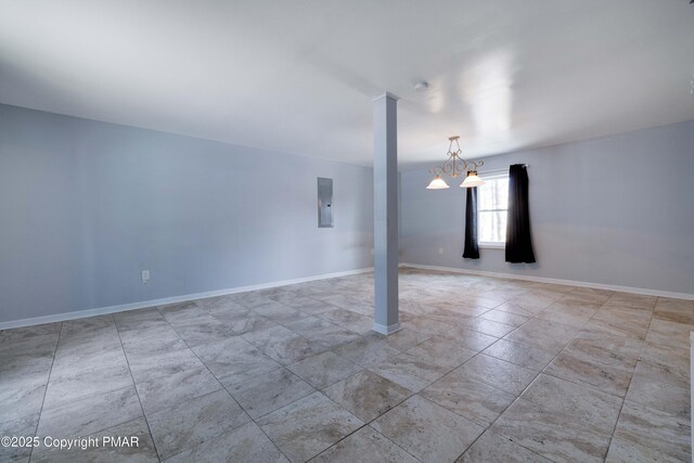 unfurnished room with decorative columns and electric panel