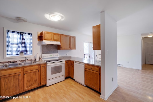 kitchen featuring sink, a baseboard heating unit, light hardwood / wood-style floors, kitchen peninsula, and white appliances